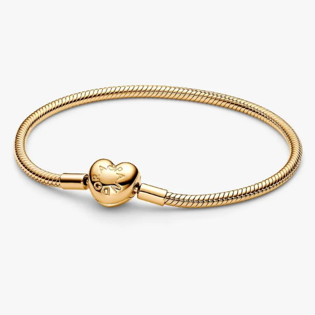 A gold-plated snake chain bracelet with a heart-shaped clasp engraved with the brand name 'PANDORA' and a fleur-de-lis, shown on a light gray background.