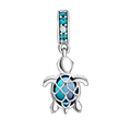 Silver turtle charm with blue accents on a white background