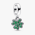 A sterling silver dangle charm featuring a four-leaf clover design set with vibrant green cubic zirconia stones, shown on a clean white background.