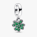 A sterling silver dangle charm featuring a four-leaf clover design set with vibrant green cubic zirconia stones, shown on a clean white background.