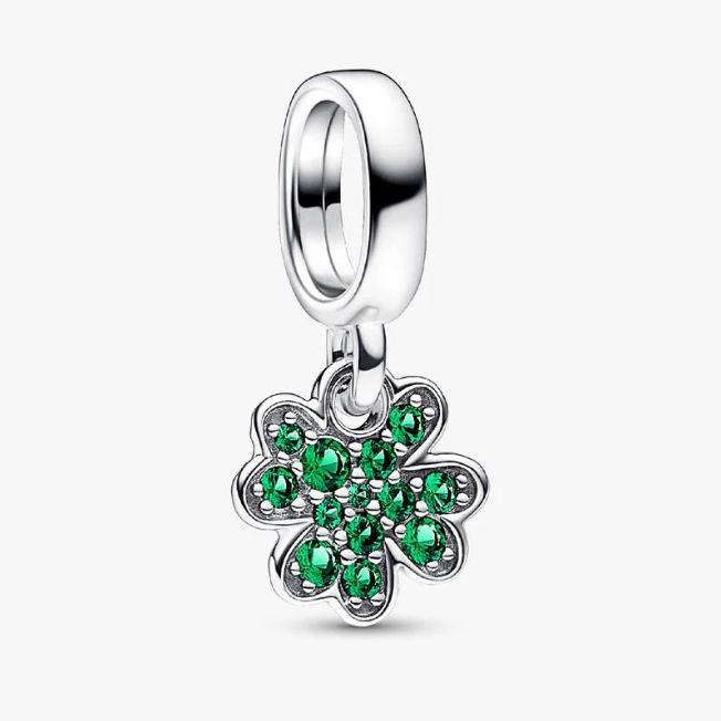 A sterling silver dangle charm featuring a four-leaf clover design set with vibrant green cubic zirconia stones, shown on a clean white background.