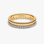 A gold Pandora ring with a row of clear pavé stones on the front band, shown on a clean white background. The inside of the band is engraved with the brand name 'PANDORA'.