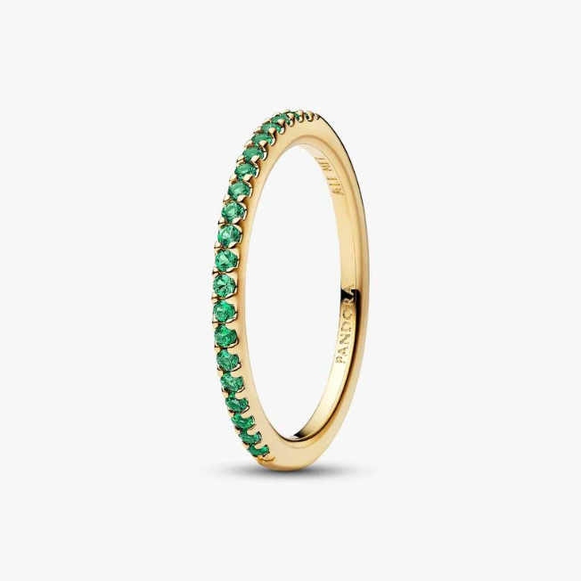 Gold ring with green gemstones on a white background