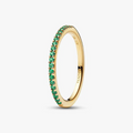 Gold ring with green gemstones on a white background