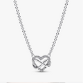 A silver heart-shaped pendant necklace featuring an infinity symbol intertwined with a heart, accented with small clear stones, on a delicate silver chain.
