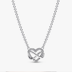 A silver heart-shaped pendant necklace featuring an infinity symbol intertwined with a heart, accented with small clear stones, on a delicate silver chain.
