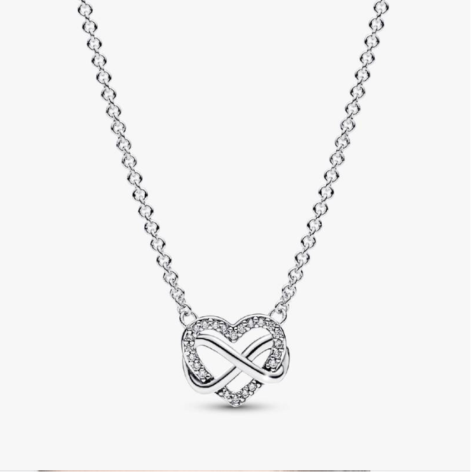 A silver heart-shaped pendant necklace featuring an infinity symbol intertwined with a heart, accented with small clear stones, on a delicate silver chain.