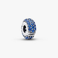 A silver charm bead featuring a textured oval face paved with deep blue rhinestones, shown on a clean white background.