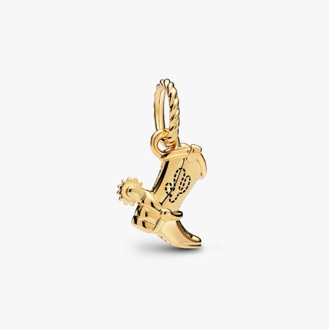 A gold cowboy boot charm with western embroidery and a rope-style bail, shown on a clean off-white background.
