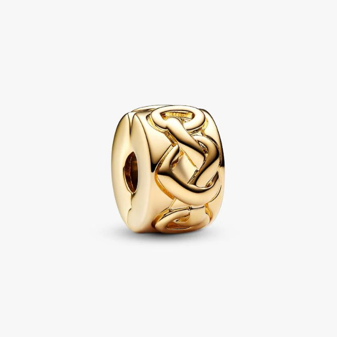 A polished gold charm bead featuring an interlocking snakeskin pattern, displayed on a clean, light gray background.