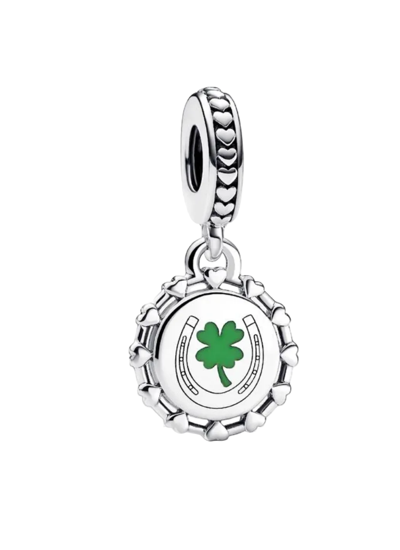 A silver charm dangle featuring a green four-leaf clover and horseshoe design on a white circular face, with a heart-patterned top loop, shown against a light gray background.