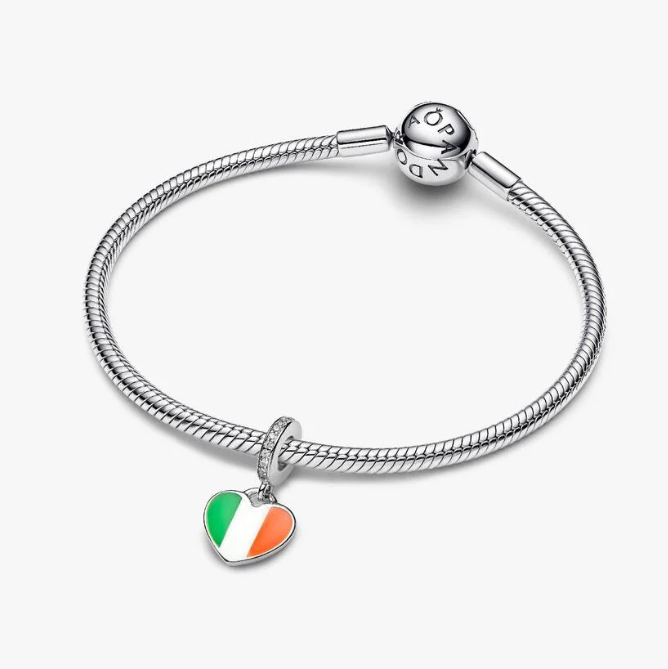 A silver-toned snake chain bracelet with a heart-shaped charm featuring the green, white, and orange colors of the Irish flag, displayed on a light gray background.