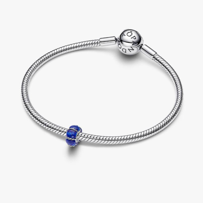 Silver bracelet with a blue bead on a white background